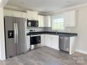 Modern kitchen featuring stainless steel appliances, white cabinetry, and dark countertops at 4044 Hurley Walters Rd, Lancaster, SC 29720