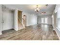 Spacious living room boasts new floors, vaulted ceiling, and French doors to the backyard at 5206 Fire Water Ln, Fort Mill, SC 29707