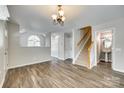 Open-concept layout featuring living room with wood floors and staircase at 5206 Fire Water Ln, Fort Mill, SC 29707