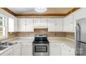 Cozy kitchen area with wooden cabinets and modern stainless steel appliances at 6915 Norchester Ct, Charlotte, NC 28227