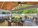 Outdoor entertaining space with covered patio, dining area, and views of the landscaped backyard at 79115 Ridgehaven Rd, Lancaster, SC 29720