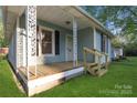 Inviting front porch with decorative railings and freshly painted stairs leading to the entrance at 872 Wellman St, Gastonia, NC 28054