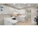 Clean kitchen with white cabinets, modern countertops, and tile flooring at 8326 Ramath Dr, Charlotte, NC 28211