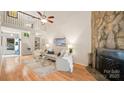 Cozy living room with stone fireplace, wood floors, and natural light at 8326 Ramath Dr, Charlotte, NC 28211