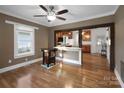 Inviting living room with hardwood floors, ceiling fan, and an open view to the kitchen and natural light from the window at 872 Wellman St, Gastonia, NC 28054