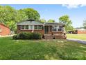 Charming single-story brick home with a well-maintained lawn and mature landscaping, exuding curb appeal at 1053 Stoneybrook Ln, Rock Hill, SC 29730