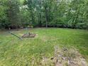 Large, lush backyard perfect for outdoor activities and relaxation at 127 Hummingbird Cir, New London, NC 28127