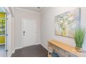Bright entryway with dark wood floors, console table, and a vibrant art piece, with an open doorway to the left at 1552 Trentwood Dr, Fort Mill, SC 29715