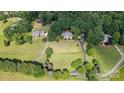 An aerial view of a well maintained property with mature trees at 15546 Thompson Rd, Mint Hill, NC 28227
