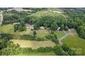 An aerial view of a well maintained property and its surrounding land at 15546 Thompson Rd, Mint Hill, NC 28227