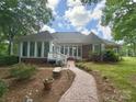 Spacious backyard with patio, brick walkway, and sunroom, perfect for entertaining at 15546 Thompson Rd, Mint Hill, NC 28227