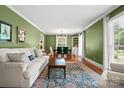 Bright living room with hardwood floors, large windows, and a comfortable seating area at 2100 Stonewood Dr, Charlotte, NC 28210