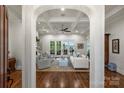 Elegant living room with coffered ceilings, hardwood floors, and doors that provide stunning lake views at 299 Barber Loop, Mooresville, NC 28117