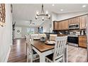 Dining area showcasing a wood table, chandelier lighting, and an open layout into the kitchen at 3615 Kimber Ln, Sherrills Ford, NC 28673