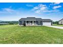 Inviting single-story home boasting a well-manicured lawn, covered porch, and charming curb appeal at 3615 Kimber Ln, Sherrills Ford, NC 28673