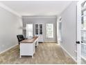 Well-lit office with a built-in bookcase and a large desk at 6005 Abergele Ln, Matthews, NC 28104