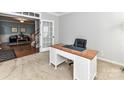 Cozy office space with a wooden desk and access to the living area at 6005 Abergele Ln, Matthews, NC 28104