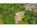 Aerial view of a newly constructed modern farmhouse nestled among lush green trees at 6712 Cove Ln, Sherrills Ford, NC 28673