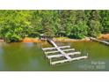 Lakefront dock featuring multiple slips for boats and personal watercraft at 6712 Cove Ln, Sherrills Ford, NC 28673