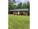 Charming one-story brick home featuring a carport, manicured lawn, and mature trees at 755 Victory Grove Church Rd, Lincolnton, NC 28092