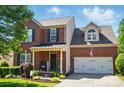 Charming two-story brick home with front porch, landscaped garden and a two-car garage at 8004 Fountainbrook Dr # 15, Indian Trail, NC 28079
