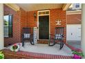 Charming porch with rocking chairs and a welcoming sign at 8004 Fountainbrook Dr # 15, Indian Trail, NC 28079