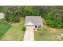 Overhead view of a charming home with long driveway, lush lawn, mature trees and landscaping at 8112 Mossy Rock Rd, Waxhaw, NC 28173