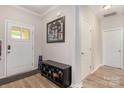 Welcoming foyer with updated flooring, shoe bench and convenient coat closet at 8112 Mossy Rock Rd, Waxhaw, NC 28173
