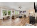 Open living room featuring large windows, recessed lighting, and modern ceiling fan at 8112 Mossy Rock Rd, Waxhaw, NC 28173