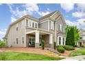 Attractive two-story home with well-manicured lawn, covered porch and steps to front door at 9802 Sky Vista Dr, Huntersville, NC 28078