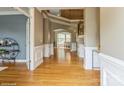 Inviting foyer with hardwood floors, wainscoting, and staircase leading to the second floor at 10012 Royal Colony Dr, Waxhaw, NC 28173