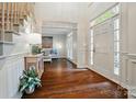 Bright foyer features gleaming wood floors and an inviting living space beyond at 10319 Remembrance Trl, Huntersville, NC 28078