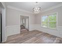 Bright dining room features modern light fixture, stylish flooring, and large window at 1033 Marguerite Dr, Lowell, NC 28098