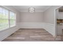 Bright dining room features modern light fixture, stylish flooring, and large window at 1033 Marguerite Dr, Lowell, NC 28098