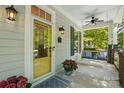 Inviting front porch features a swing, ceiling fan, and decorative door at 1038 Gardenia St, Fort Mill, SC 29708