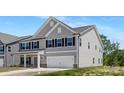 Charming two-story home featuring gray siding, black shutters, and a two-car garage at 111 Stonewater Dr # 25, Red Cross, NC 28129