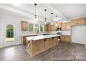 Bright kitchen boasts a large island, wood cabinets, stainless appliances, and a door leading to the outdoors, filling the space with light at 111 Stonewater Dr # 25, Red Cross, NC 28129