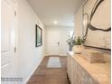 Inviting entryway with hardwood flooring, decorative rug, and stylish console table at 12136 Devon Square Ct, Charlotte, NC 28262
