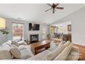 Bright living room with hardwood floors, fireplace, large windows, and an open floor plan at 12628 Waterfall Pl, Charlotte, NC 28278