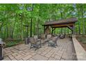 Outdoor patio with fireplace, comfortable seating and heaters for enjoying the outdoors year-round at 1305 Anniston Pl, Wesley Chapel, NC 28079