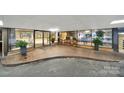 Grand entrance of the condo features seating, tiled floors, and glass doors at 1323 Queens Rd # 420, Charlotte, NC 28207