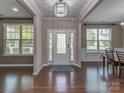 Inviting foyer with a chandelier, hardwood floors, and a front door with decorative glass at 140 Halifax Dr, Fort Mill, SC 29707