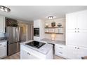 Modern kitchen features stainless steel appliances, white cabinetry, and granite countertops at 1488 Ernest Rd, York, SC 29745
