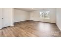 Bright, spacious living room with beautiful floors, a door and large windows at 1530 Cottage Creek Dr, Bessemer City, NC 28016