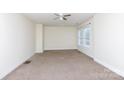 Bright bedroom with a ceiling fan and natural light from a large window at 166 Still Ave, Fort Mill, SC 29715