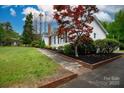 Exterior view with a brick-lined walkway, driveway, and red Japanese maple tree at 166 Still Ave, Fort Mill, SC 29715