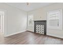 Bright room showcasing dark vinyl floors and a fireplace with decorative tiles at 18 Douglas Nw Ave, Concord, NC 28025