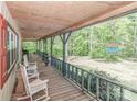 Spacious covered porch with rocking chairs, perfect for enjoying the serene outdoor views at 212 Davies Cir, Cleveland, NC 27013