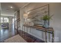 Inviting foyer with dark hardwood floors, elegant console table, and stylish decor at 247 Tackle Box Dr, Troutman, NC 28166