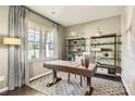 Bright office space with large window, stylish shelving, and a wooden desk on a patterned rug at 247 Tackle Box Dr, Troutman, NC 28166